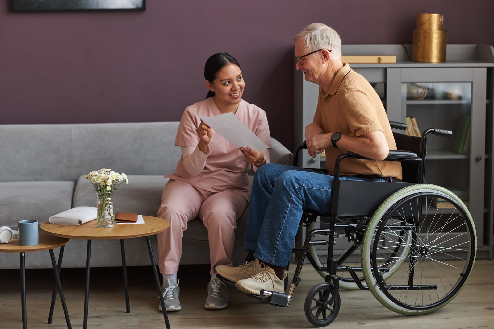 A carer going through a document with an older client at home